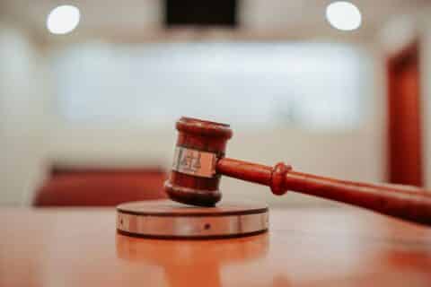 A wooden judge’s gavel rests on a sound block atop a table in a courtroom, with blurred lights and benches in the background—capturing the solemn atmosphere where law firms like Wijn & Stael pursue justice. A wooden judge’s gavel rests on a sound block atop a table in a courtroom, with blurred lights and benches in the background—capturing the solemn atmosphere where law firms like Wijn & Stael pursue justice.